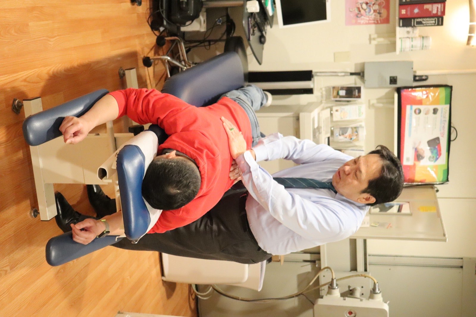 Dr. Chen treating a patient at the adjusting table